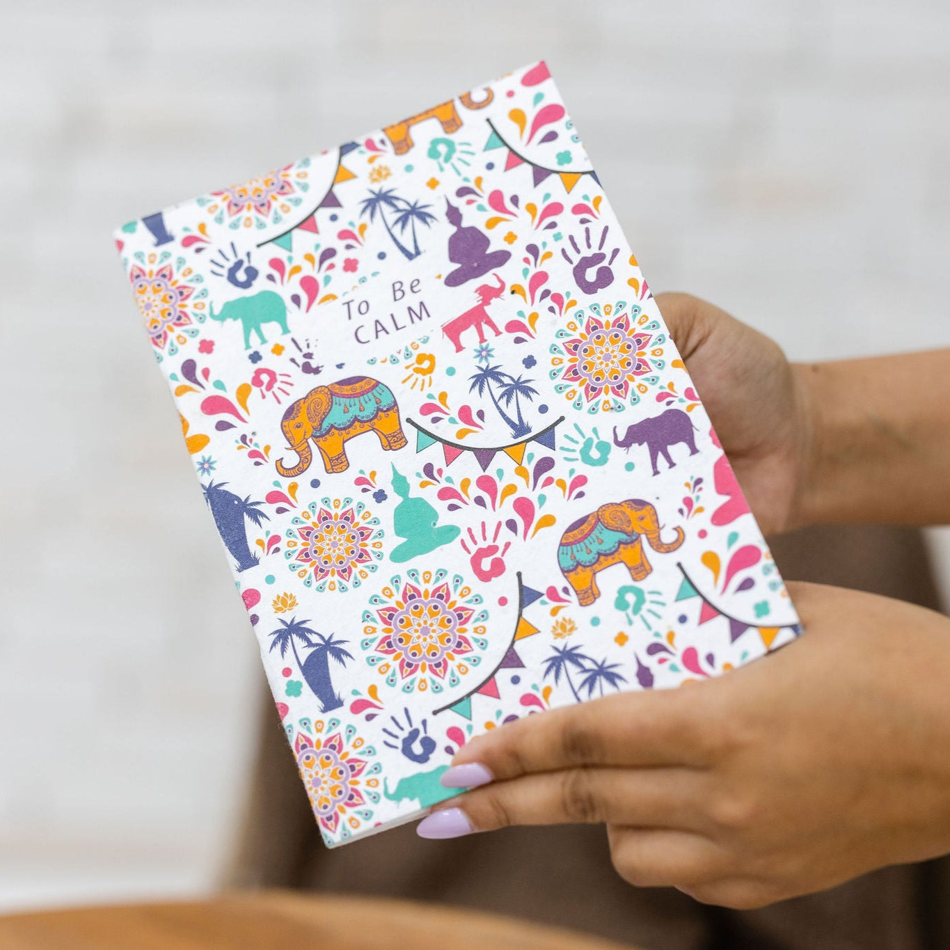 woman using the buddha plantable seed notebook plantable corporate gifts