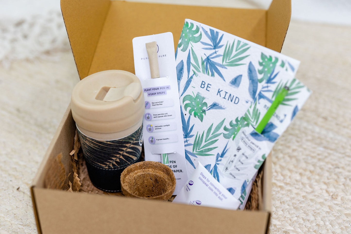 a box containing purple & pure green living essentials for plantable corporate gifts