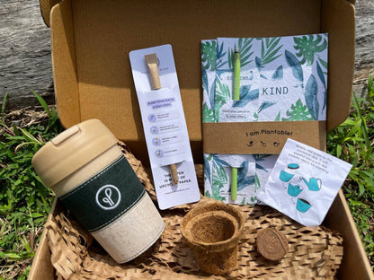 a box containing purple & pure green living essentials for plantable corporate gifts